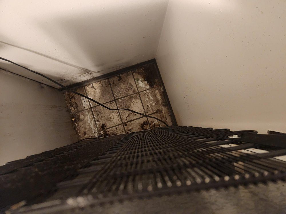 Behind appliance before cleaning
